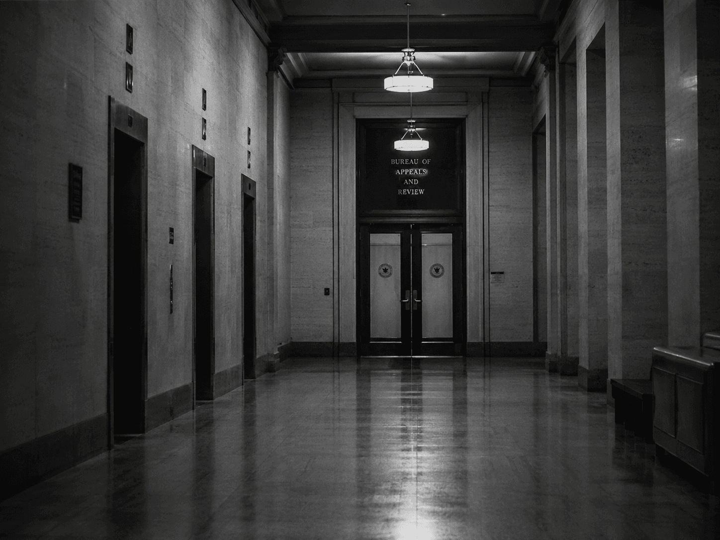 Empty courtroom, wooden benches, afternoon light through high windows
